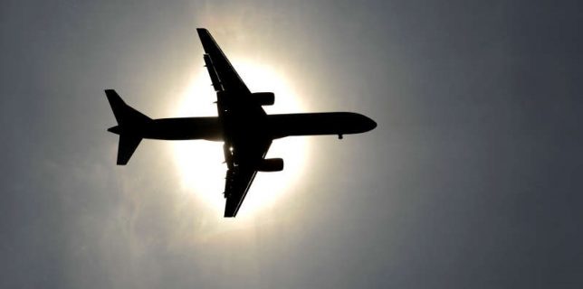 FILE PHOTO: Plane approaching Leeds Bradford airport passes in front of the sun during the second test cricket match between England and New Zealand in Leeds