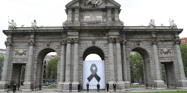 Poster cu o panglică neagră, plasat pe faţada unui celebru monument din Madrid, Puerta de Alcalá